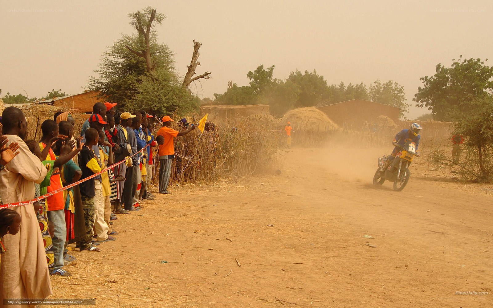 Motorcycle racer on dusty road