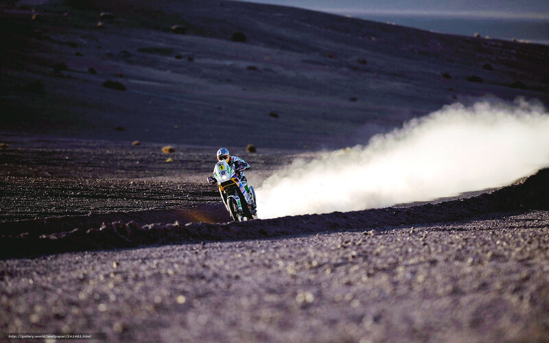 Motorcycle racer on dusty terrain