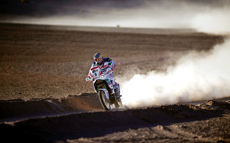 Motorcycle racer on dusty track