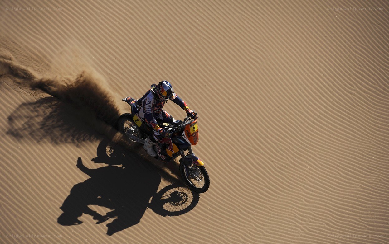 Motorcycle racer on sand dune