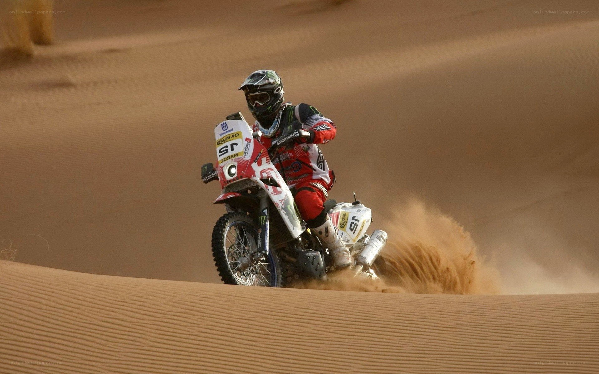 Motorcycle racer on sand dune