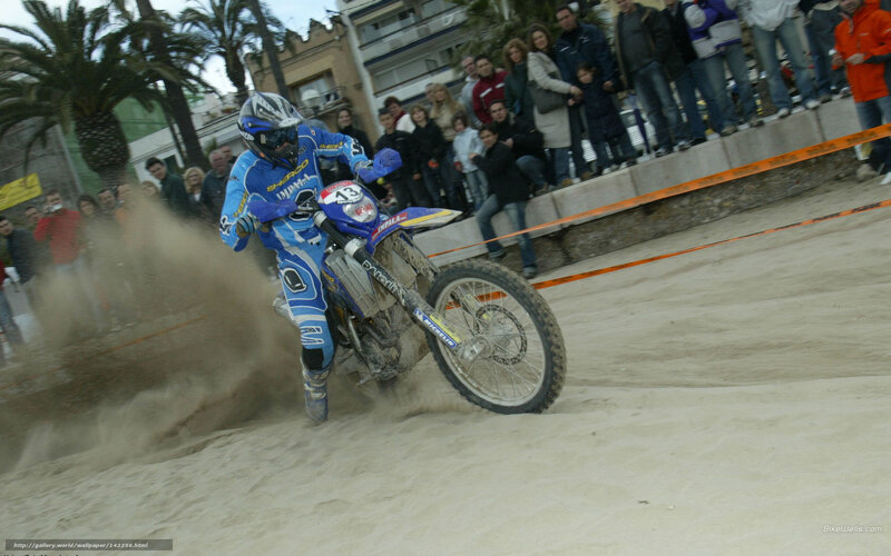 Motorcycle racer on sandy track