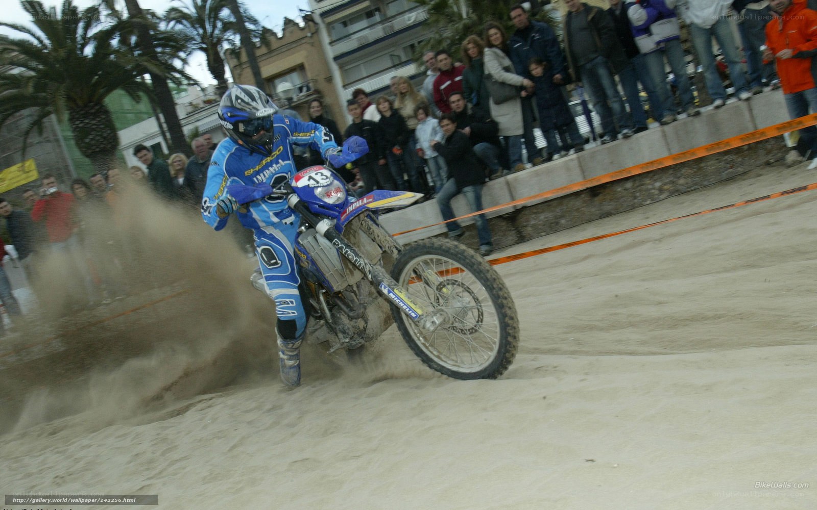Motorcycle racer on sandy track