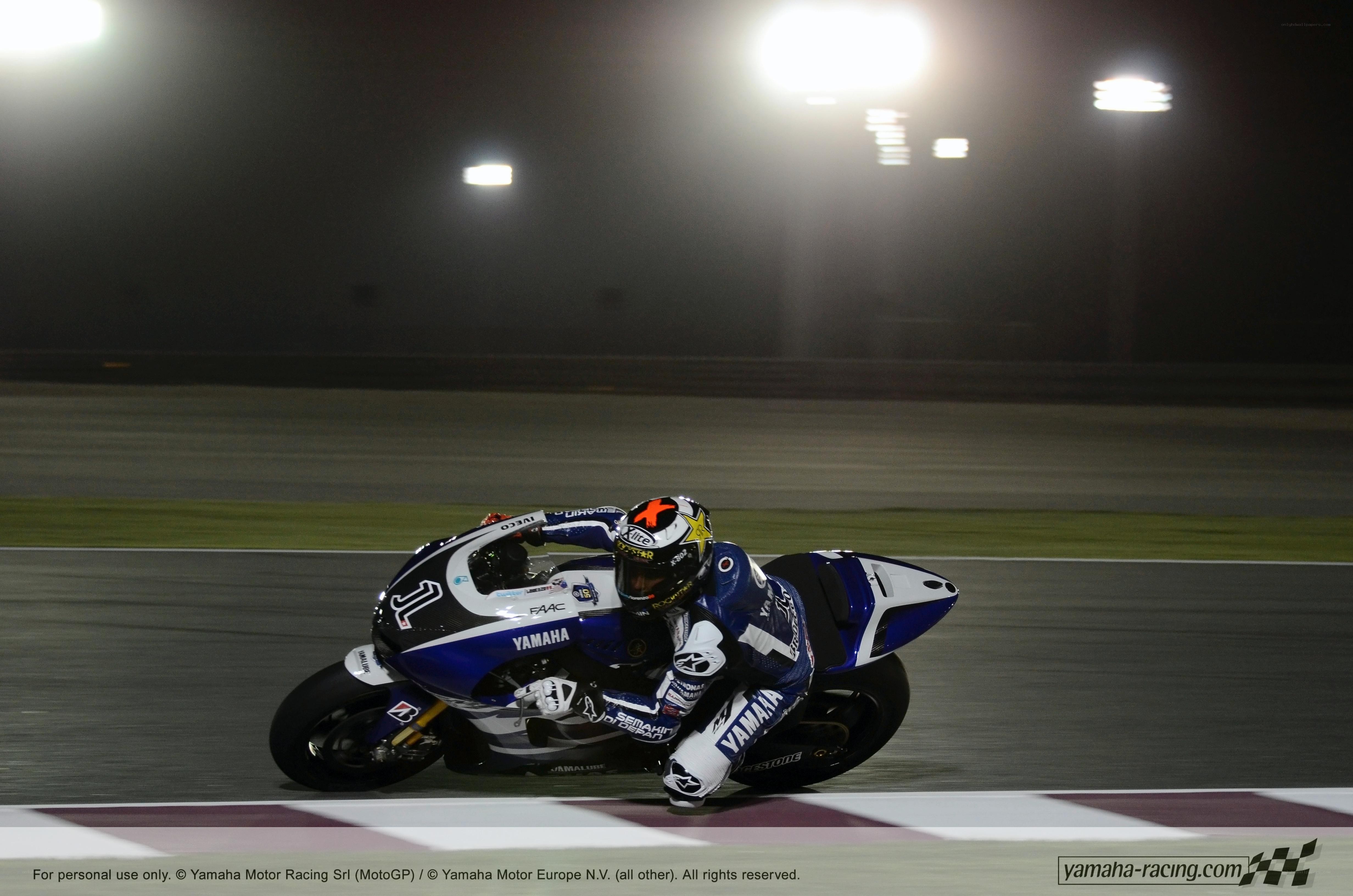 Motorcycle racer on track at night