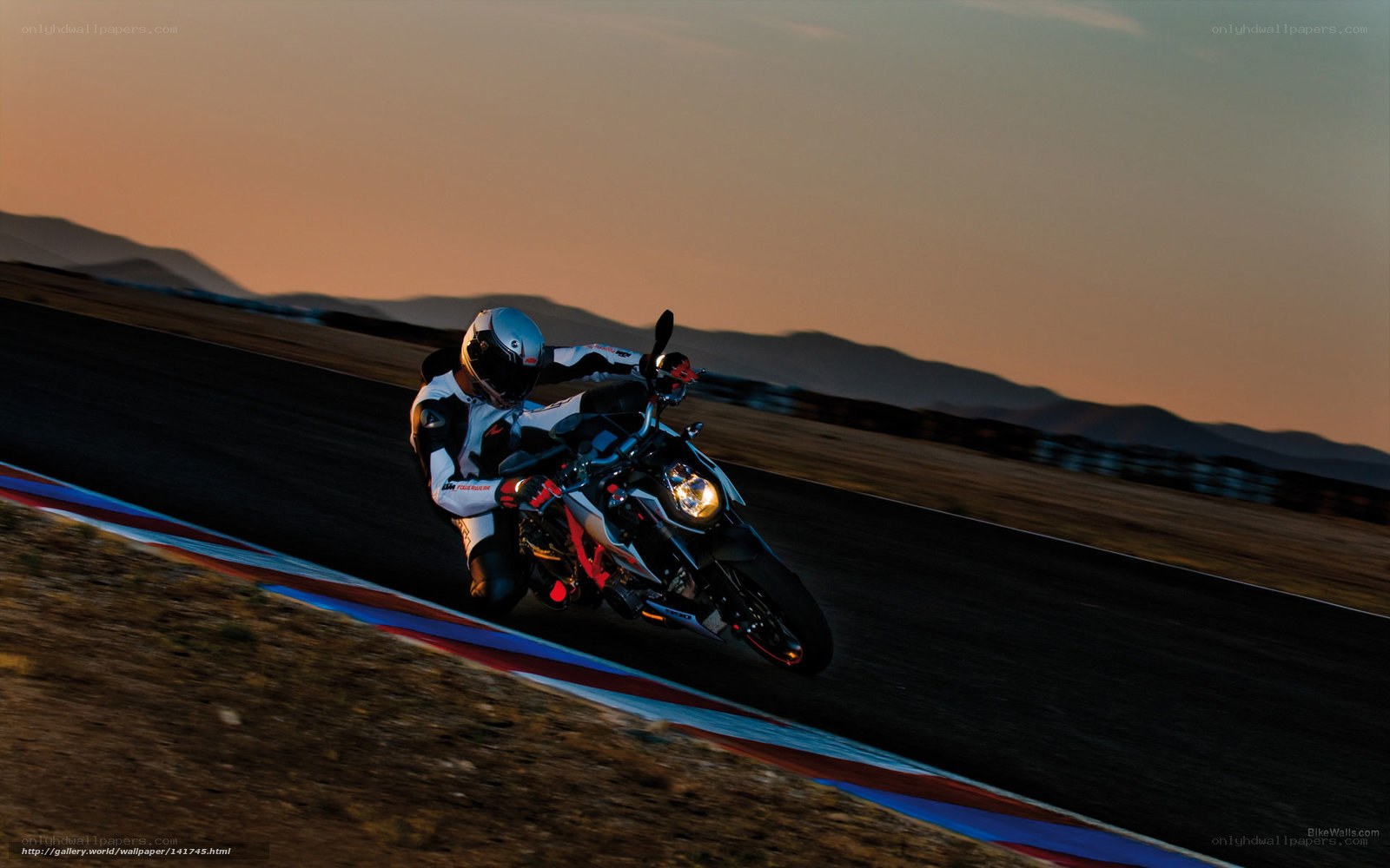 Motorcycle racer on track at sunset