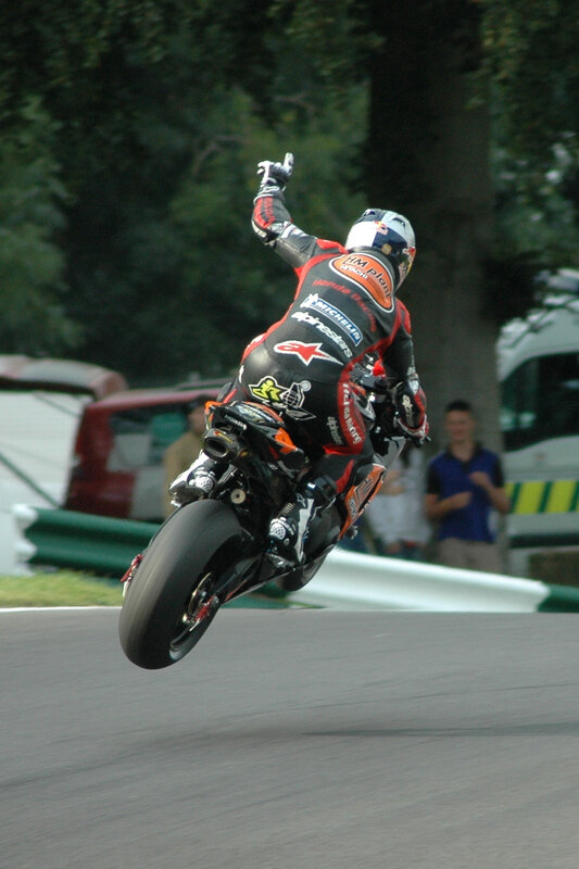 Motorcycle Racer on Track — Black, Dynamic, Afternoon, Photograph, Trees, Spectator, Red