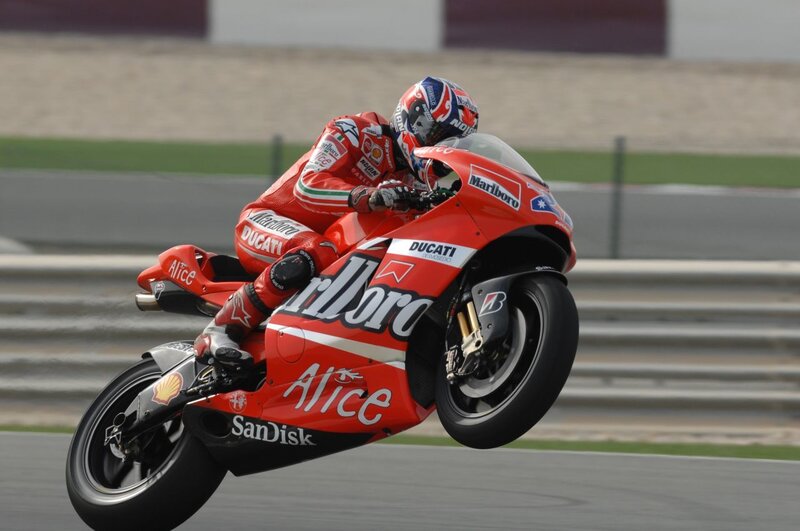 Motorcycle Racer on Track — Red, Dynamic, Photograph, Racing Suit, Helmet, Black, White