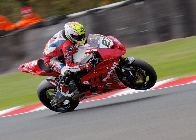 Motorcycle Racer on Track — Red, Dynamic, Photograph, Racing Suit, Helmet, Grass