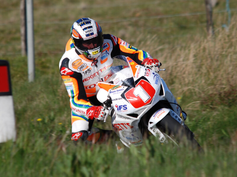 Motorcycle Racer on Track — White, Dynamic, Afternoon, Photograph, Racing Suit, Helmet, Grass