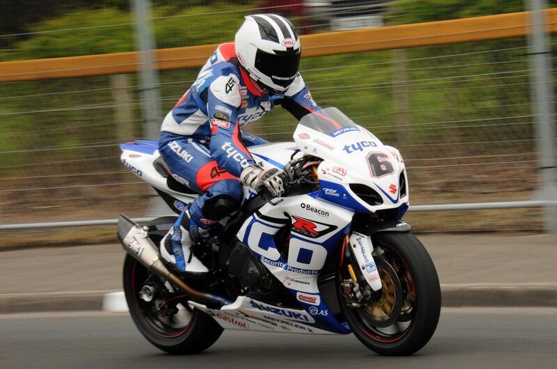 Motorcycle Racer on Track — White, Dynamic, Photograph, Racing Suit, Fence
