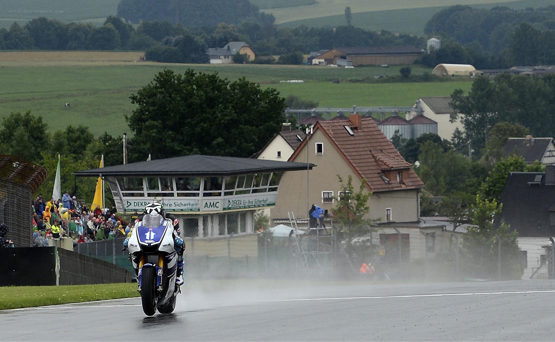 Motorcycle racer on wet track