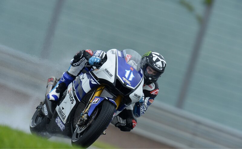 Motorcycle racer on wet track