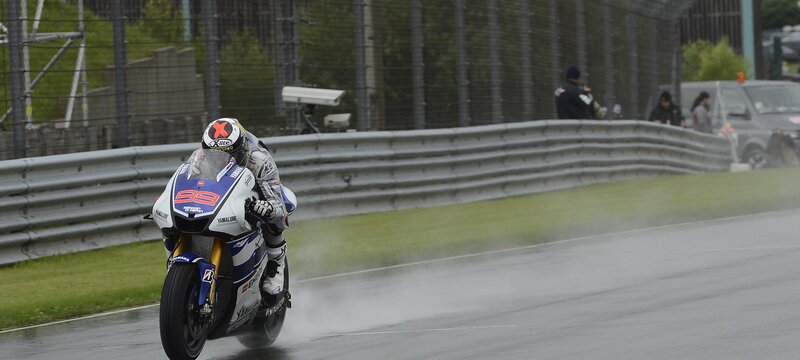 Motorcycle racer on wet track