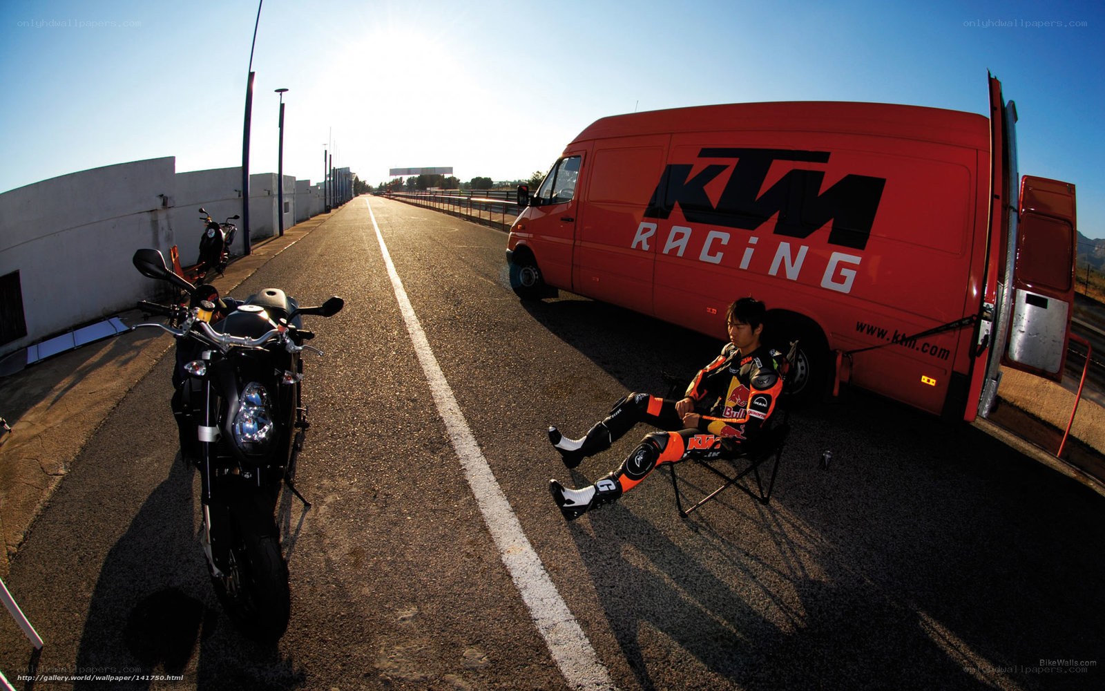 Motorcycle racer resting on track