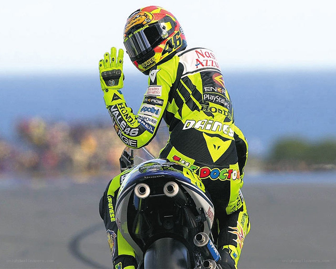 Motorcycle racer waving to crowd