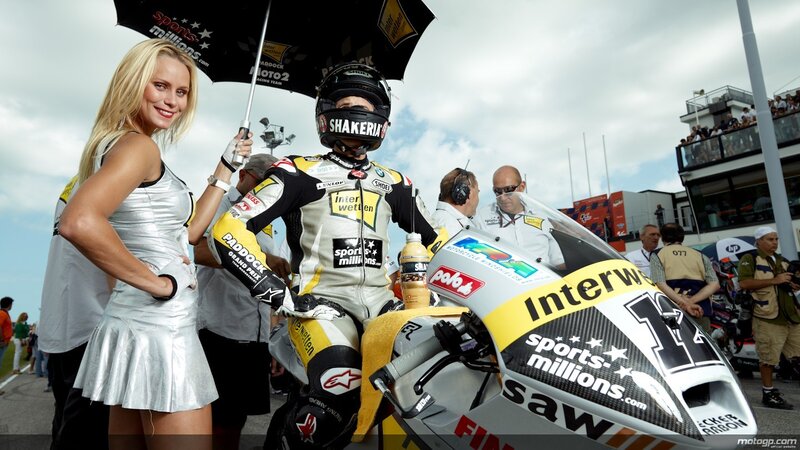 Motorcycle racer with grid girl