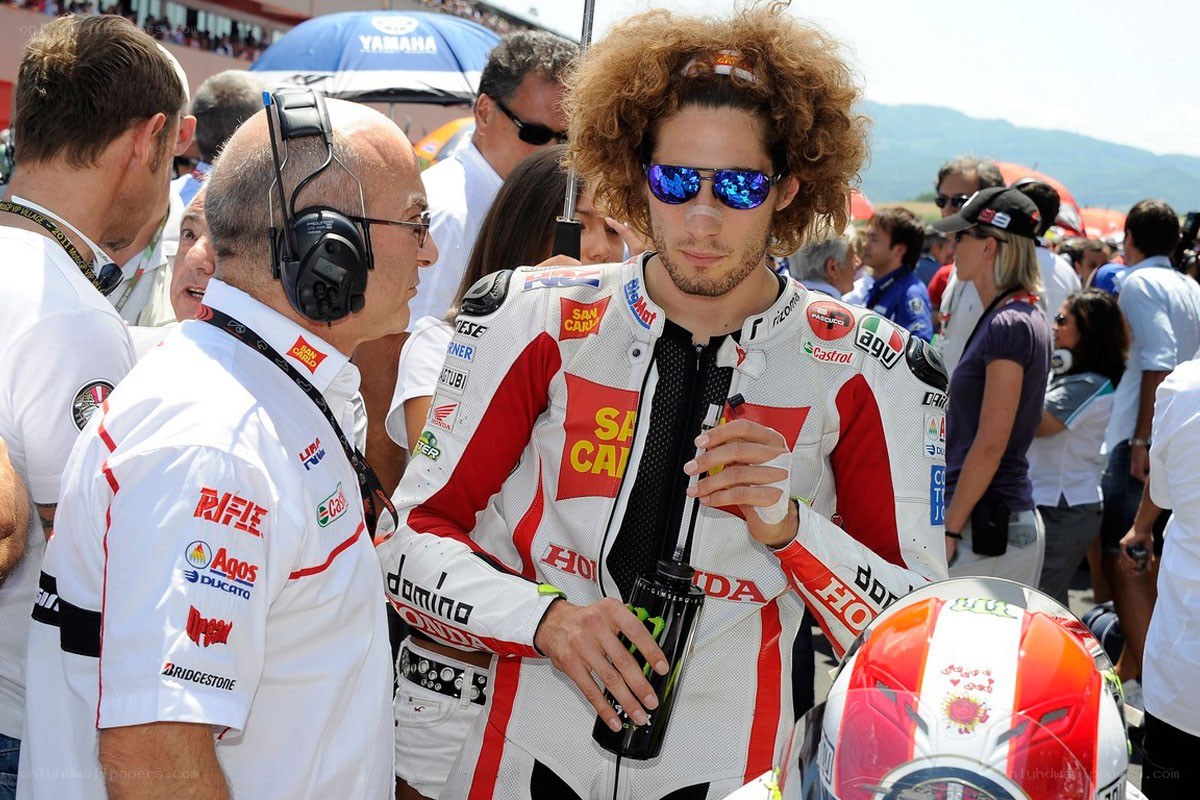 Motorcycle racer with team member