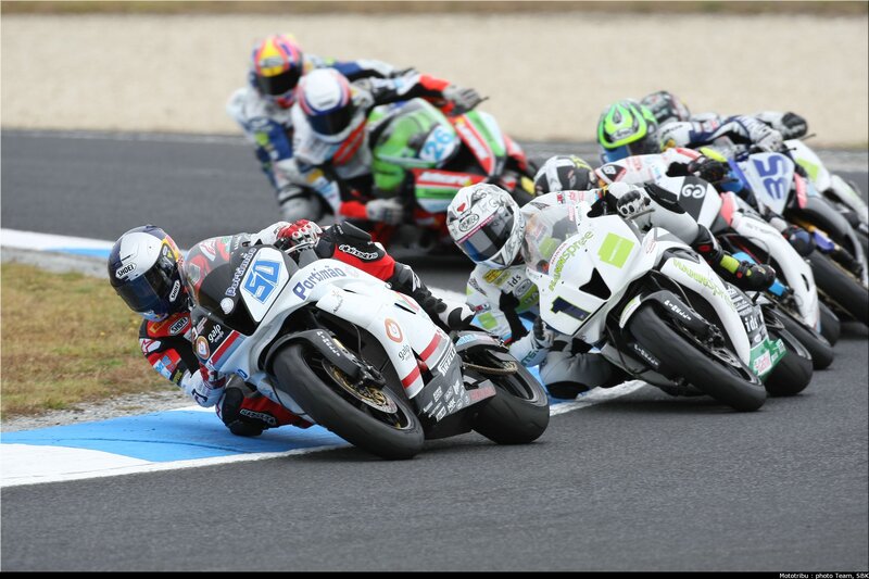 Motorcycle racers in a tight turn