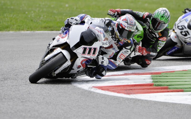 Motorcycle racers in a tight turn