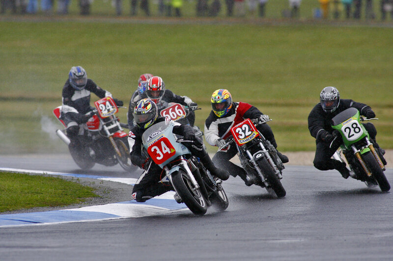 Motorcycle racers on a wet track