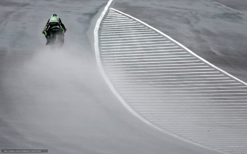 Motorcycle racing on wet track