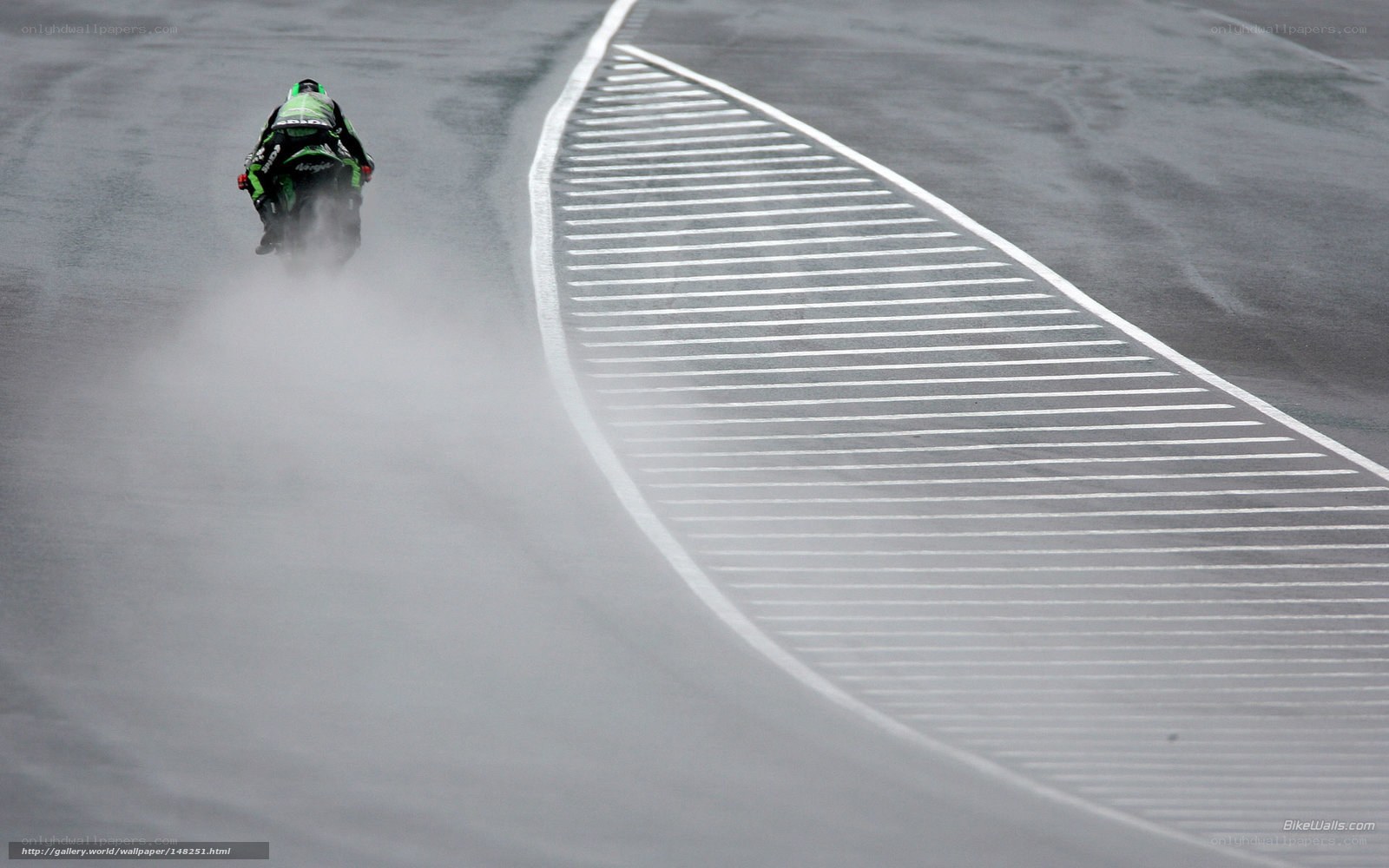 Motorcycle racing on wet track