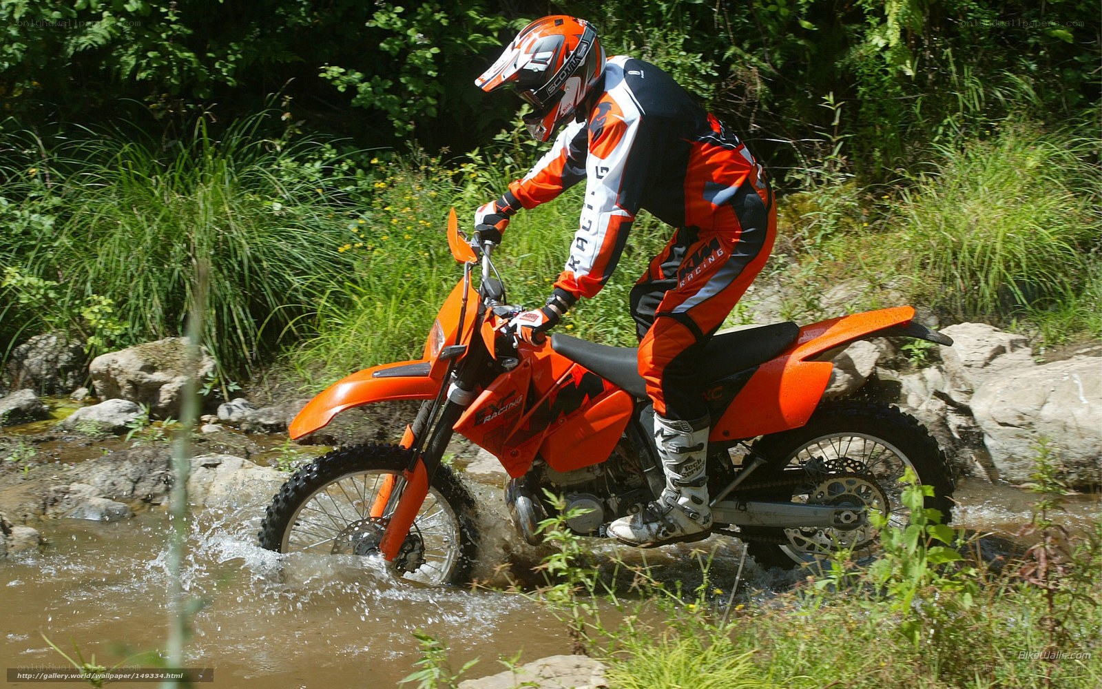 Motorcycle rider crossing stream