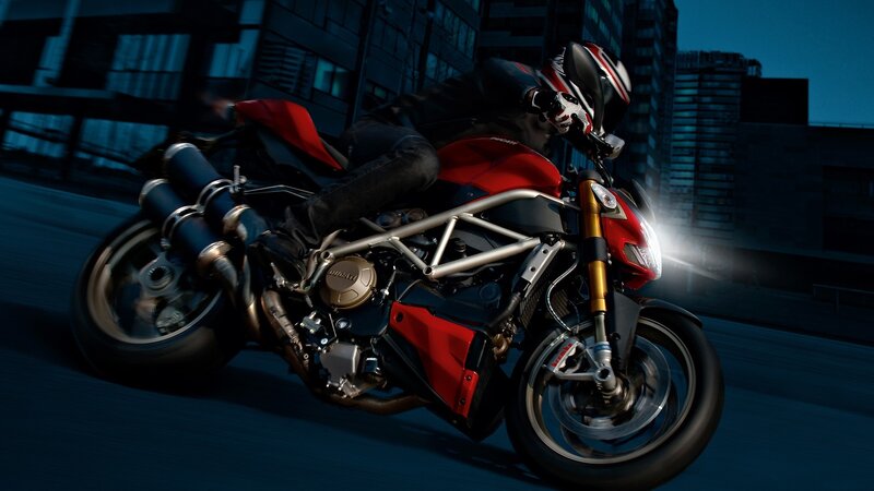 Motorcycle rider in city at night