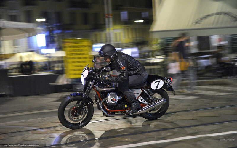 Motorcycle rider in city at night