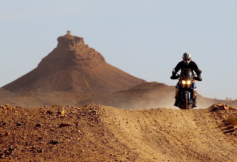 Motorcycle rider in desert landscape