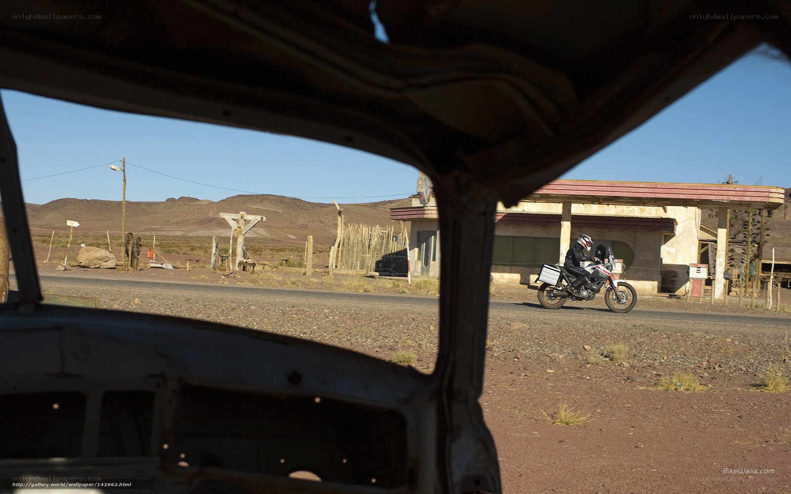 Motorcycle rider in desert landscape