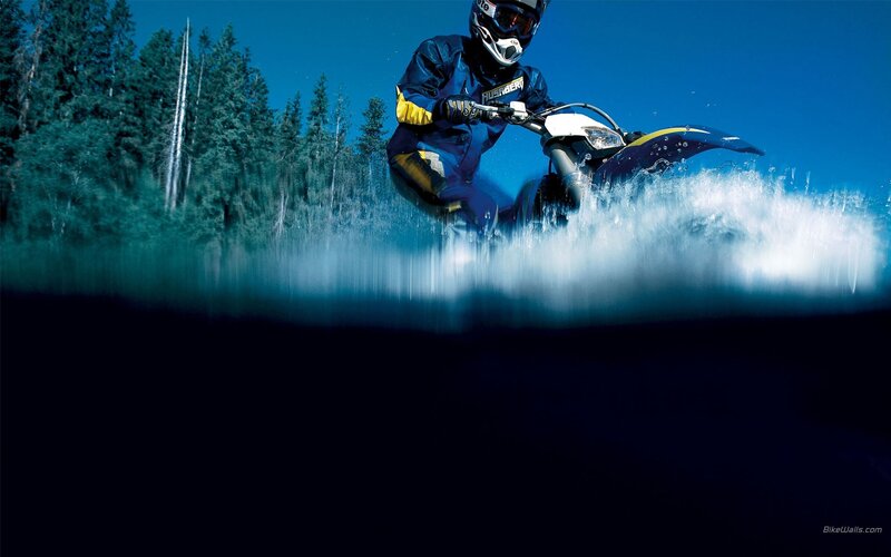 Motorcycle rider in forest water