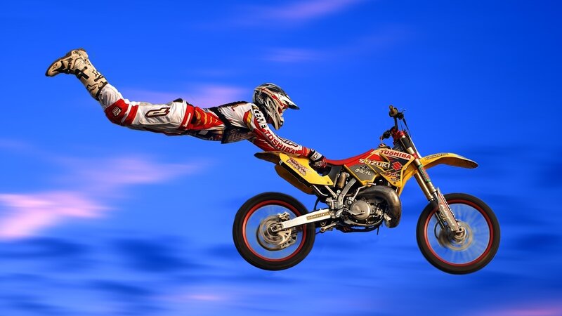 Motorcycle Rider in Mid-air — Blue, Dramatic, Afternoon