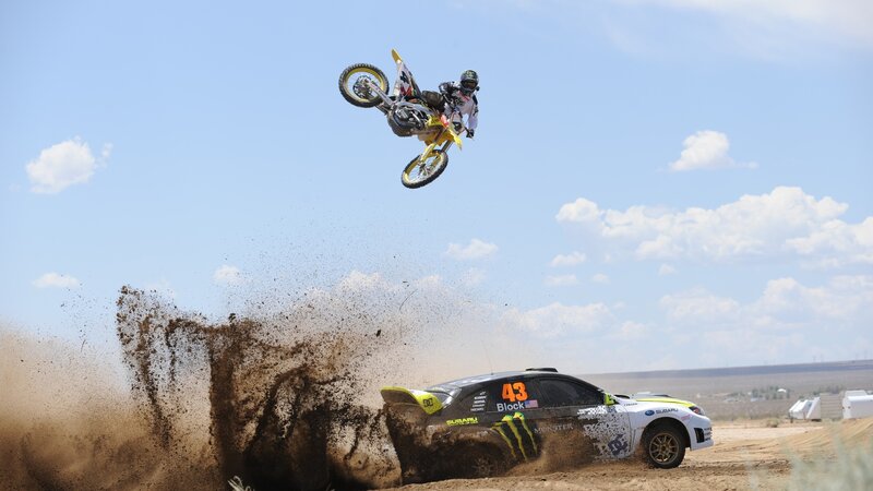 Motorcycle Rider in Mid-air — Blue, Dynamic, Afternoon, Photograph, Car