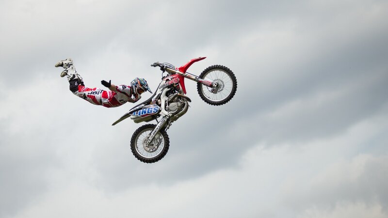 Motorcycle Rider in Mid-air — Gray, Dramatic, Photograph