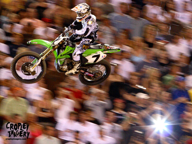 Motorcycle Rider in Mid-air — Green, Dynamic, Night, Photograph, Crowd