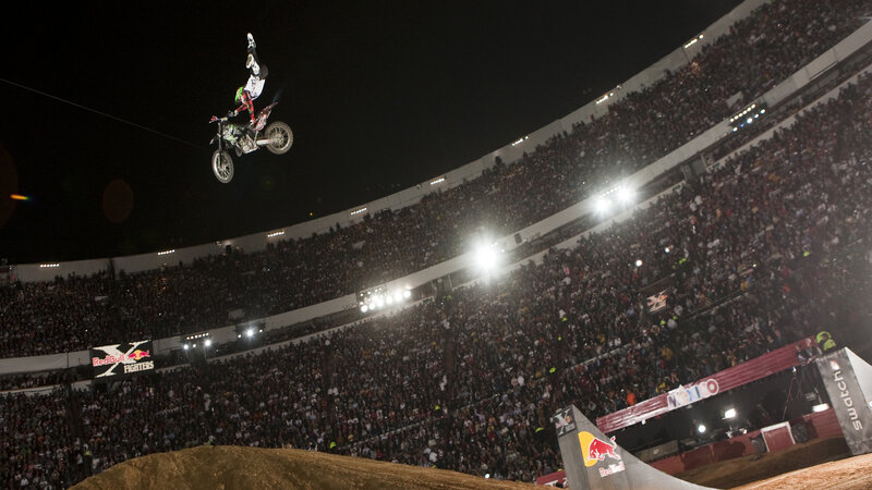Motorcycle rider in mid-air stunt