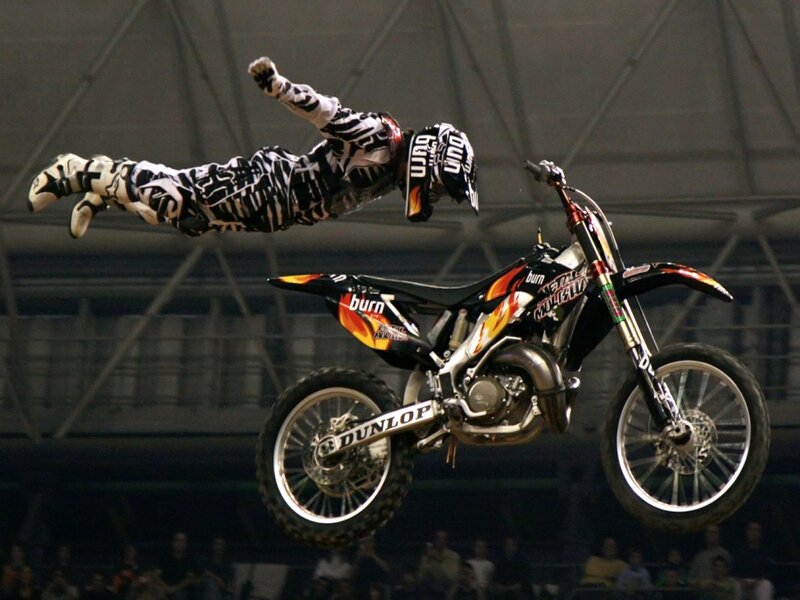 Motorcycle rider in mid-air stunt