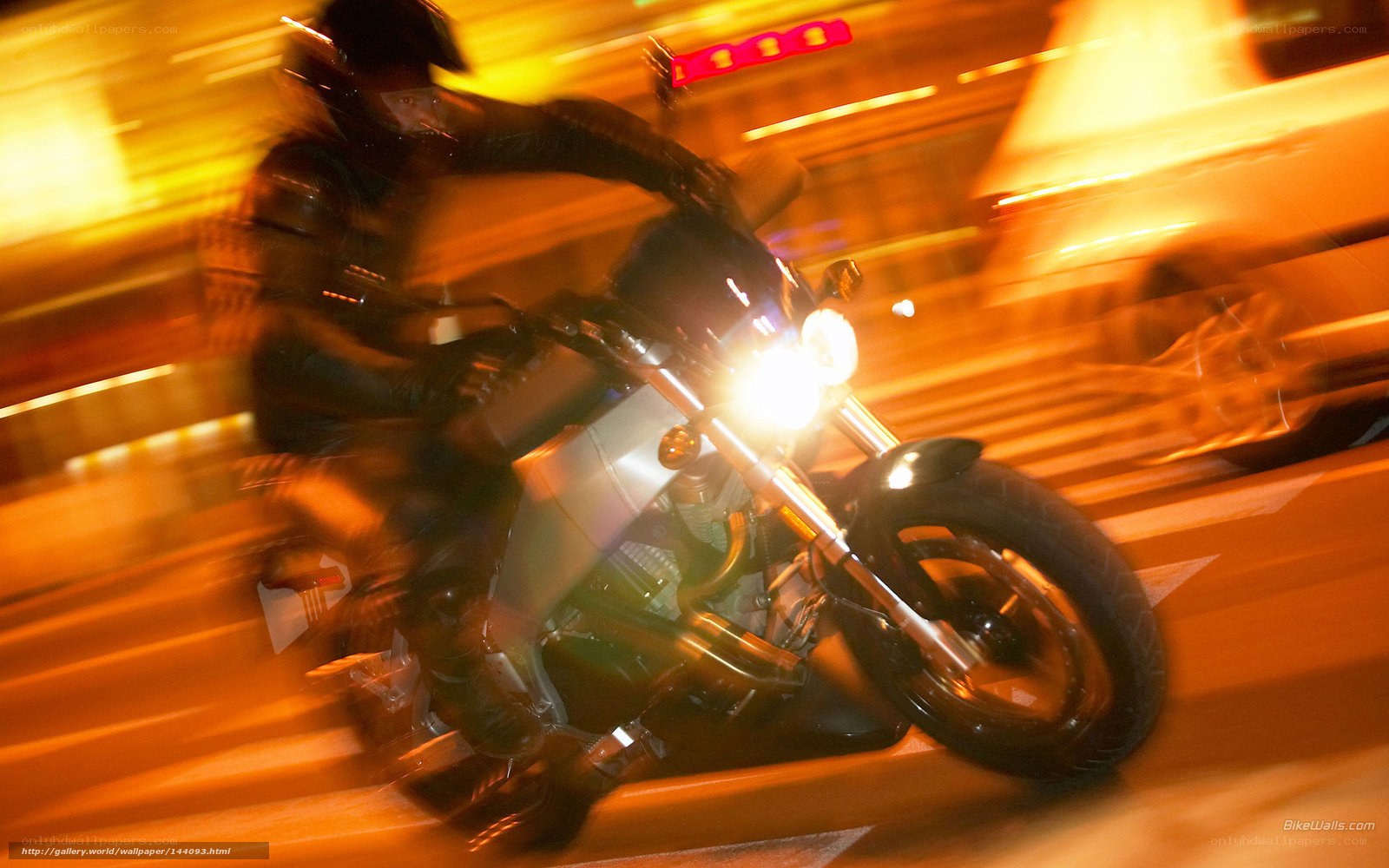Motorcycle rider in motion at night