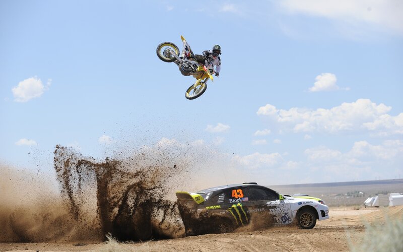 Motorcycle rider jumps over car