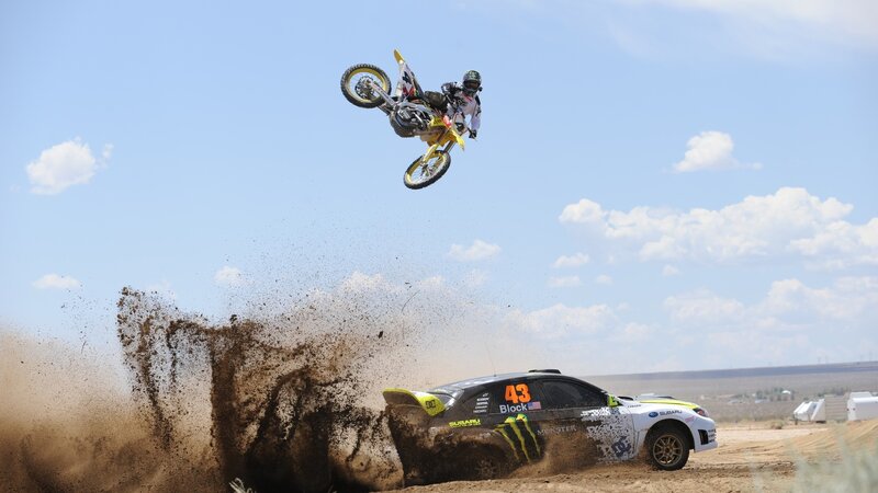 Motorcycle rider jumps over car