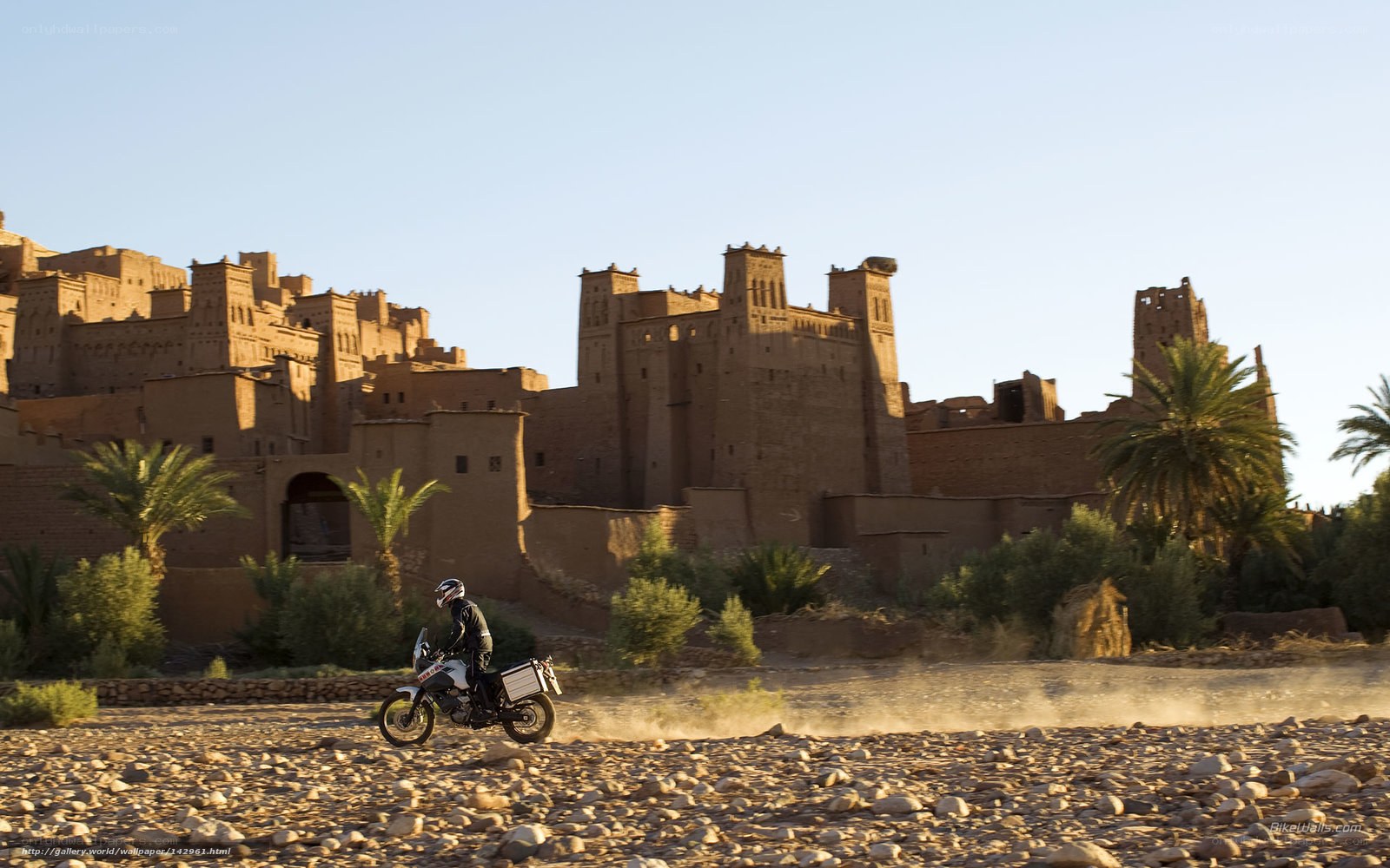 Motorcycle rider near ancient fortress