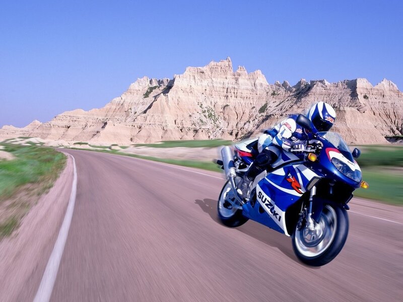 Motorcycle rider on a scenic road