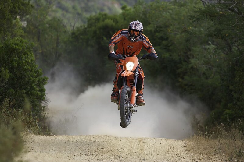 Motorcycle rider on dirt path
