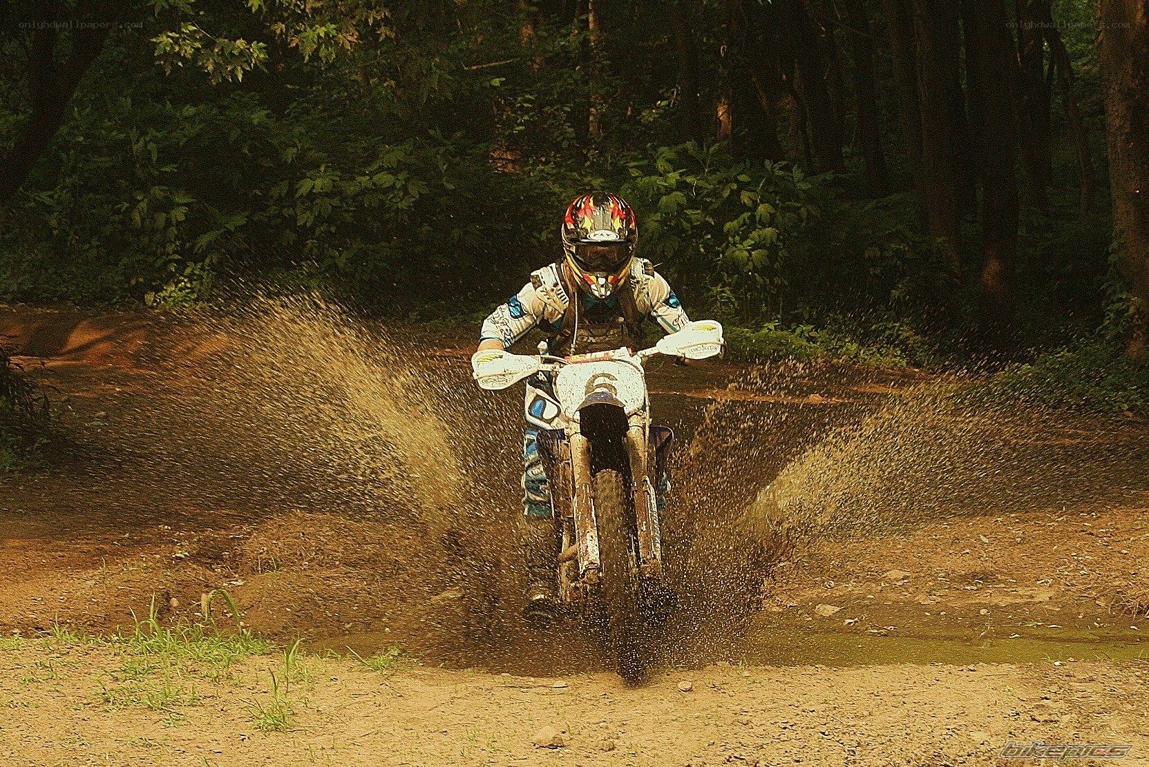 Motorcycle rider on dirt path