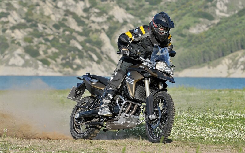 Motorcycle rider on dirt path
