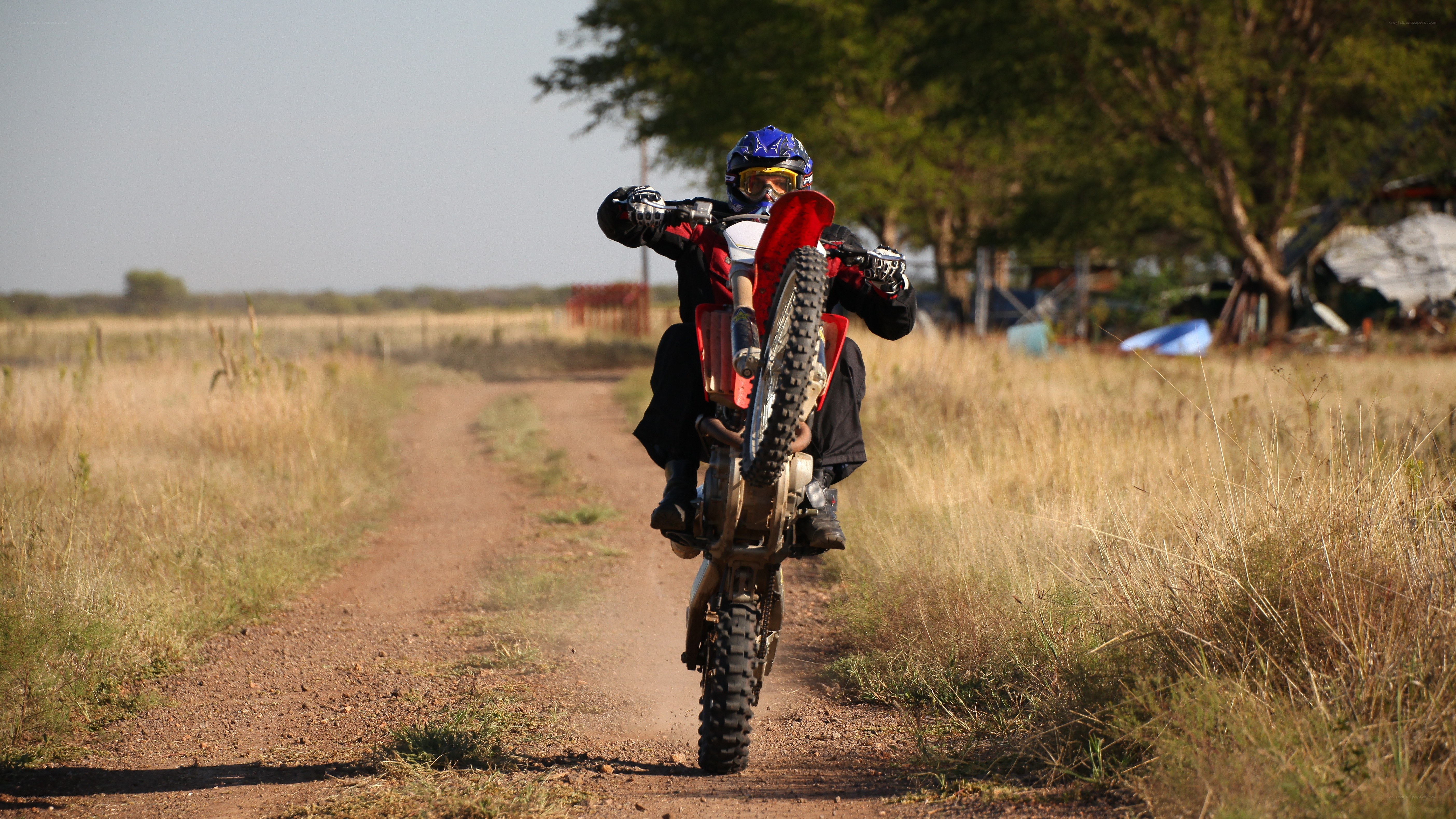 Motorcycle rider on dirt path