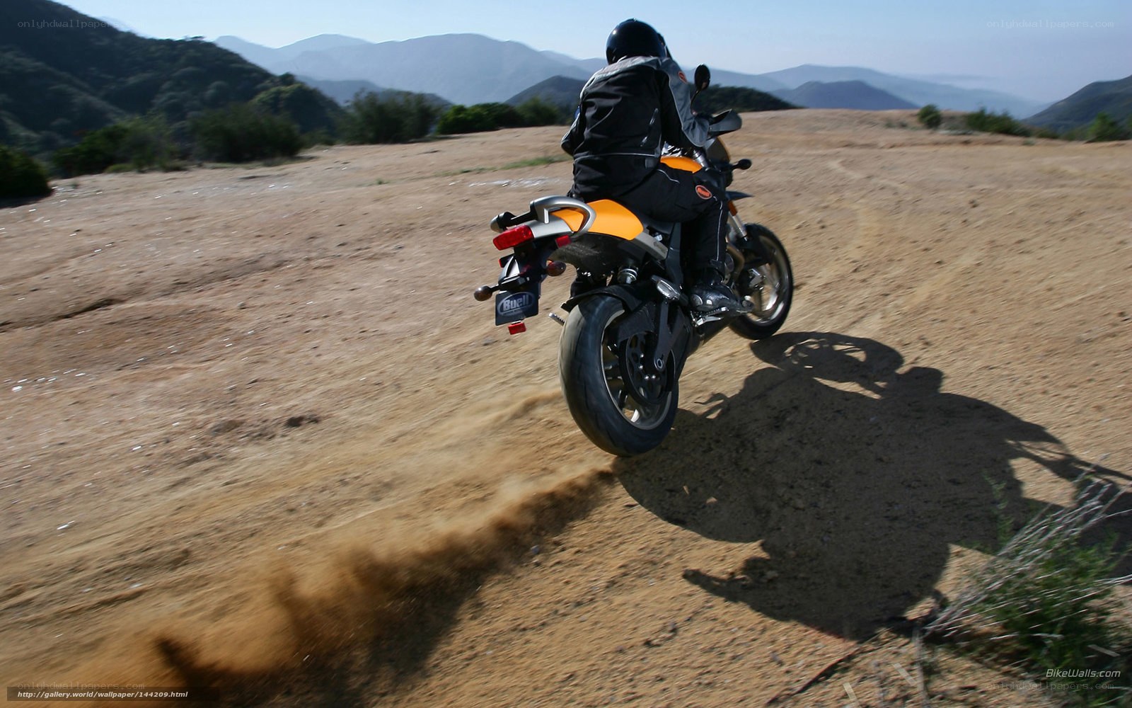 Motorcycle rider on dirt path