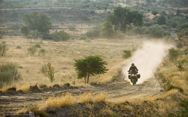 Motorcycle rider on dusty trail
