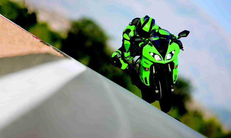 motorcycle rider on green bike